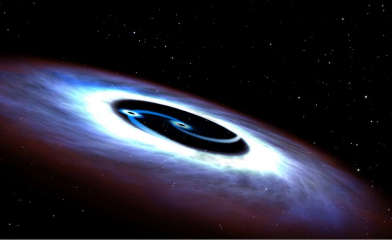 Dwie czarne dziury spiralnie krążą wokół siebie. Astronomia 